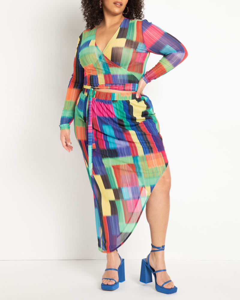 Front of a model wearing a size 26|28 Asymmetrical Curved Midi Skirt in Psychedelic Blocks by ELOQUII. | dia_product_style_image_id:290195